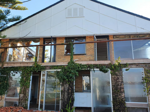 Residential demolition project Residential demolition of a house with broken windows